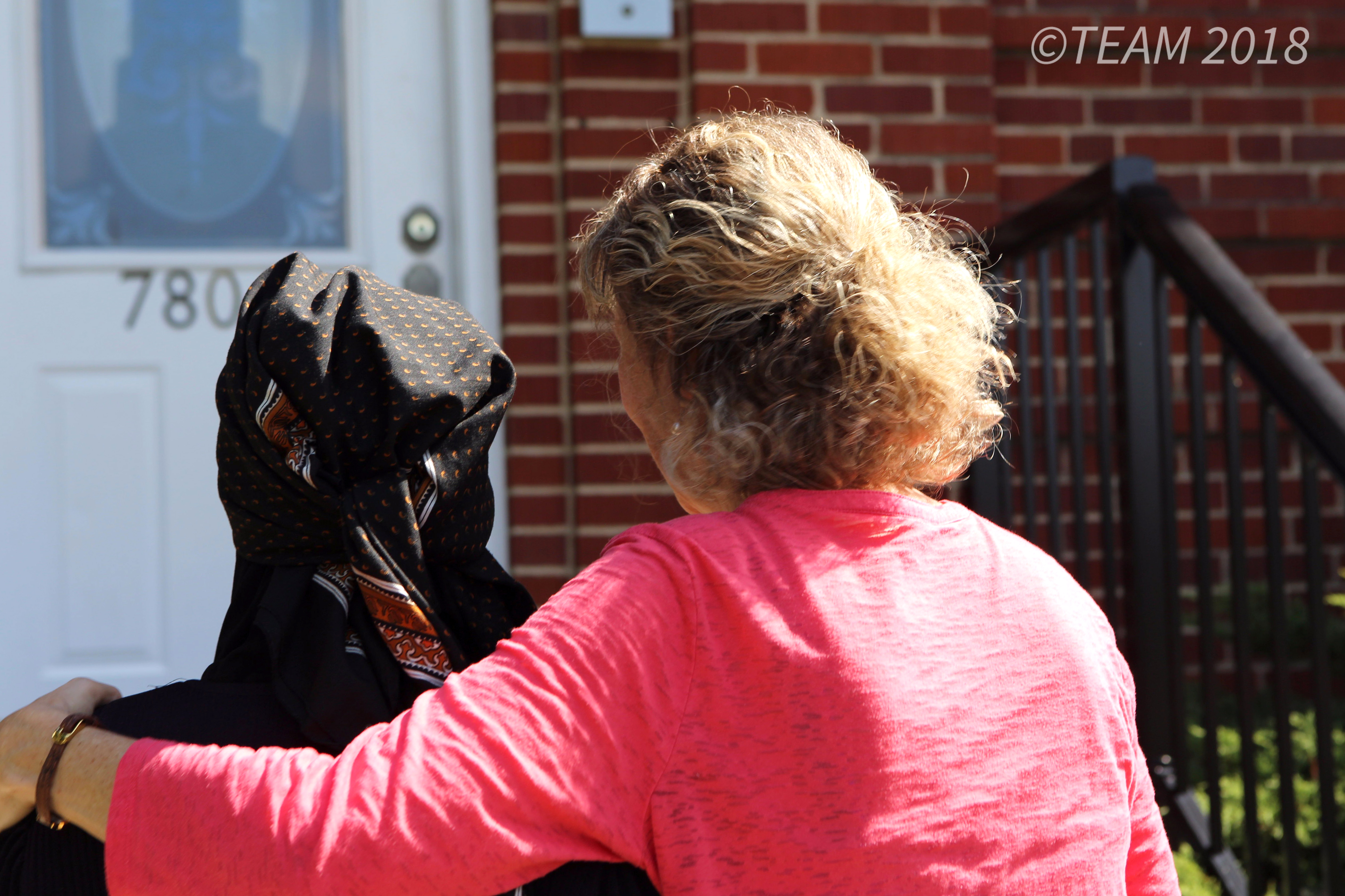 An American missionary and a Muslim refugee embrace despite their different religions.