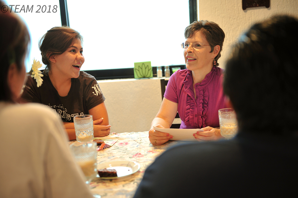 Two women sit and discuss the Bible