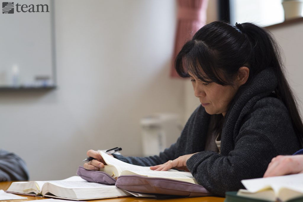 A woman studies her Bible