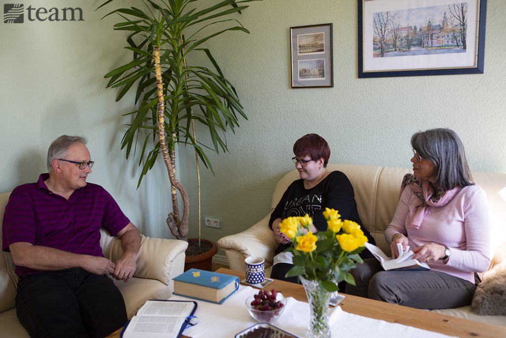 Jeff and Anne Ingram sit and talk with one of their friends in Germany