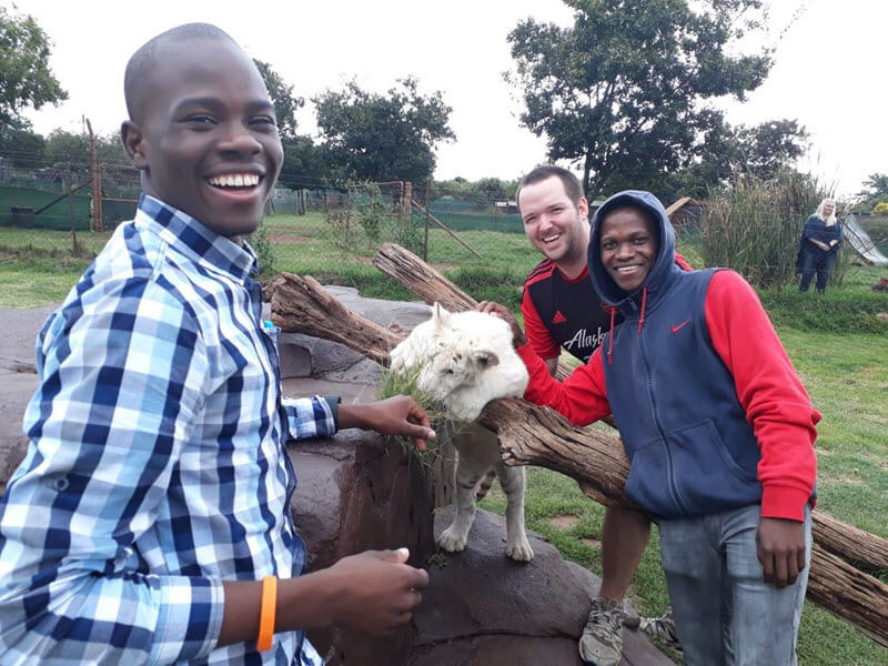 Missionary with goat and two friends