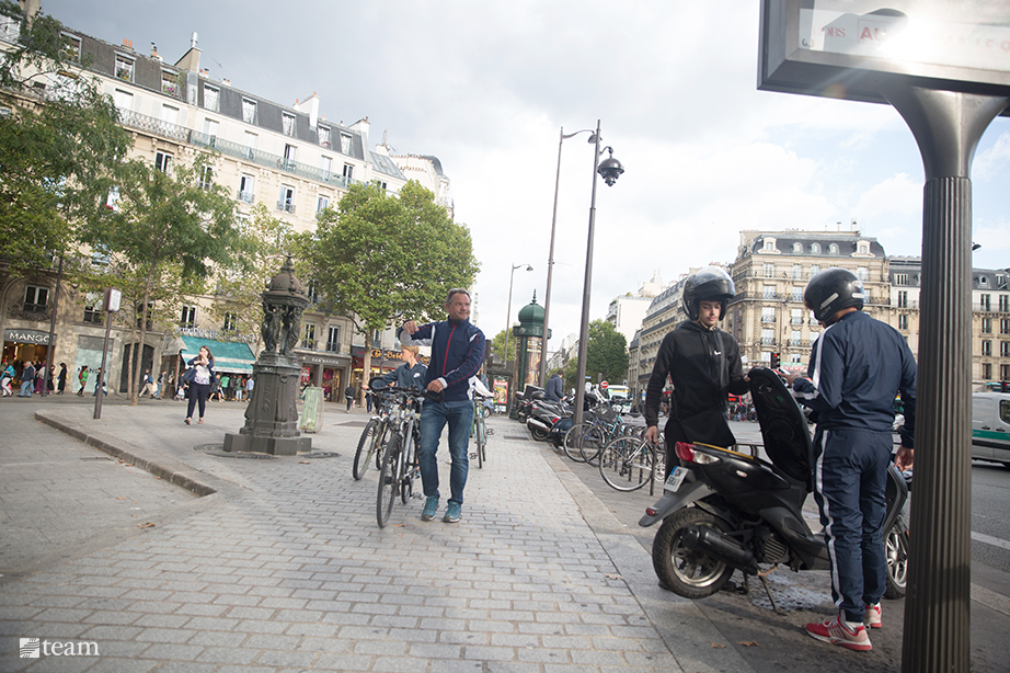 Man walking bike on the streets in France