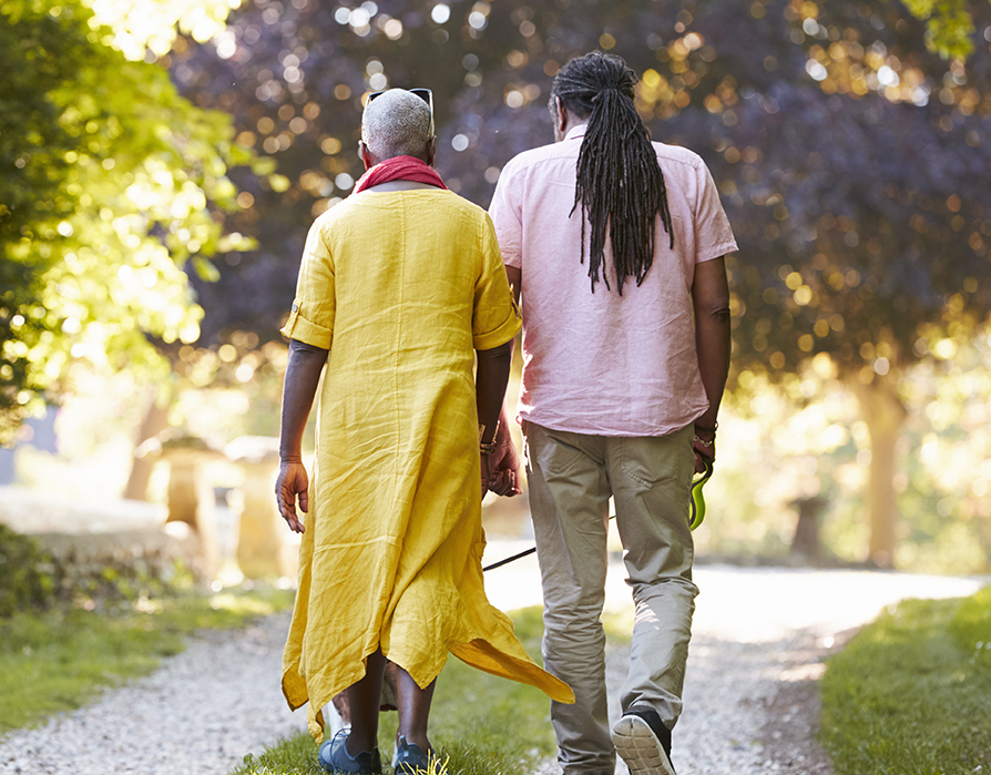 African American couple holding hands and walking.