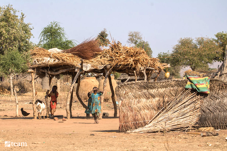 Two children walking in a village in Chad.