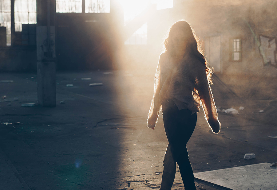 Woman walking in sunlight