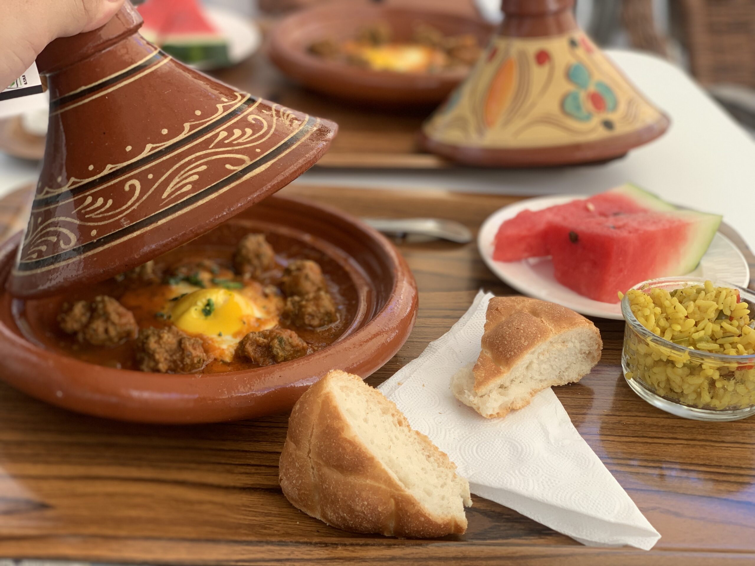 A meal in decorative pots on a table.