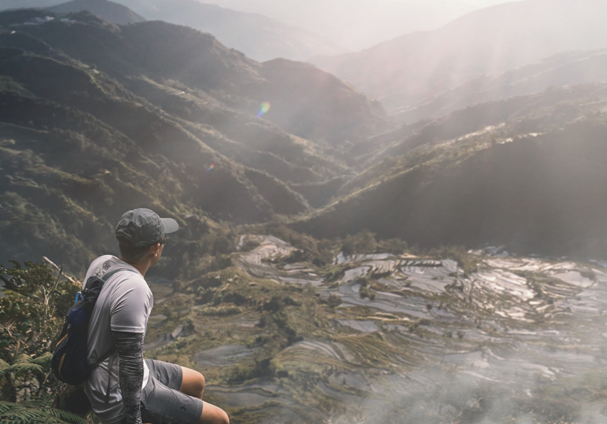 Man sitting looking over a field.