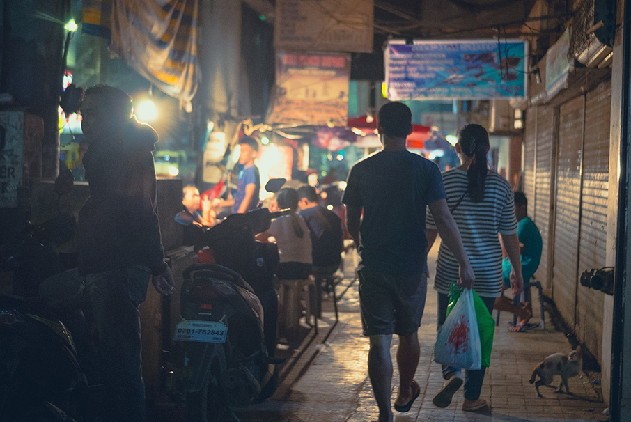 Couple walking through an Asian market.