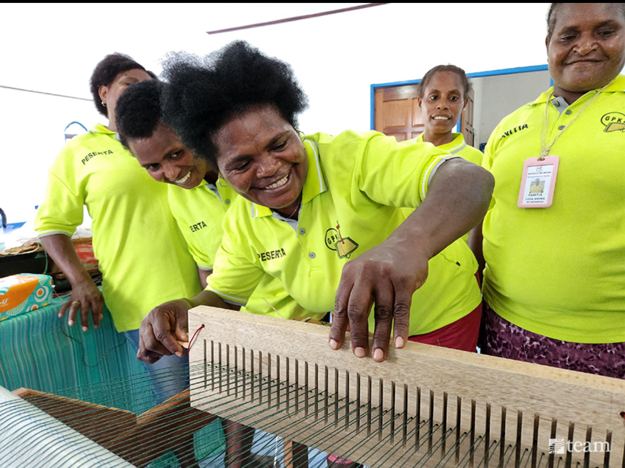 Group working on a loom.