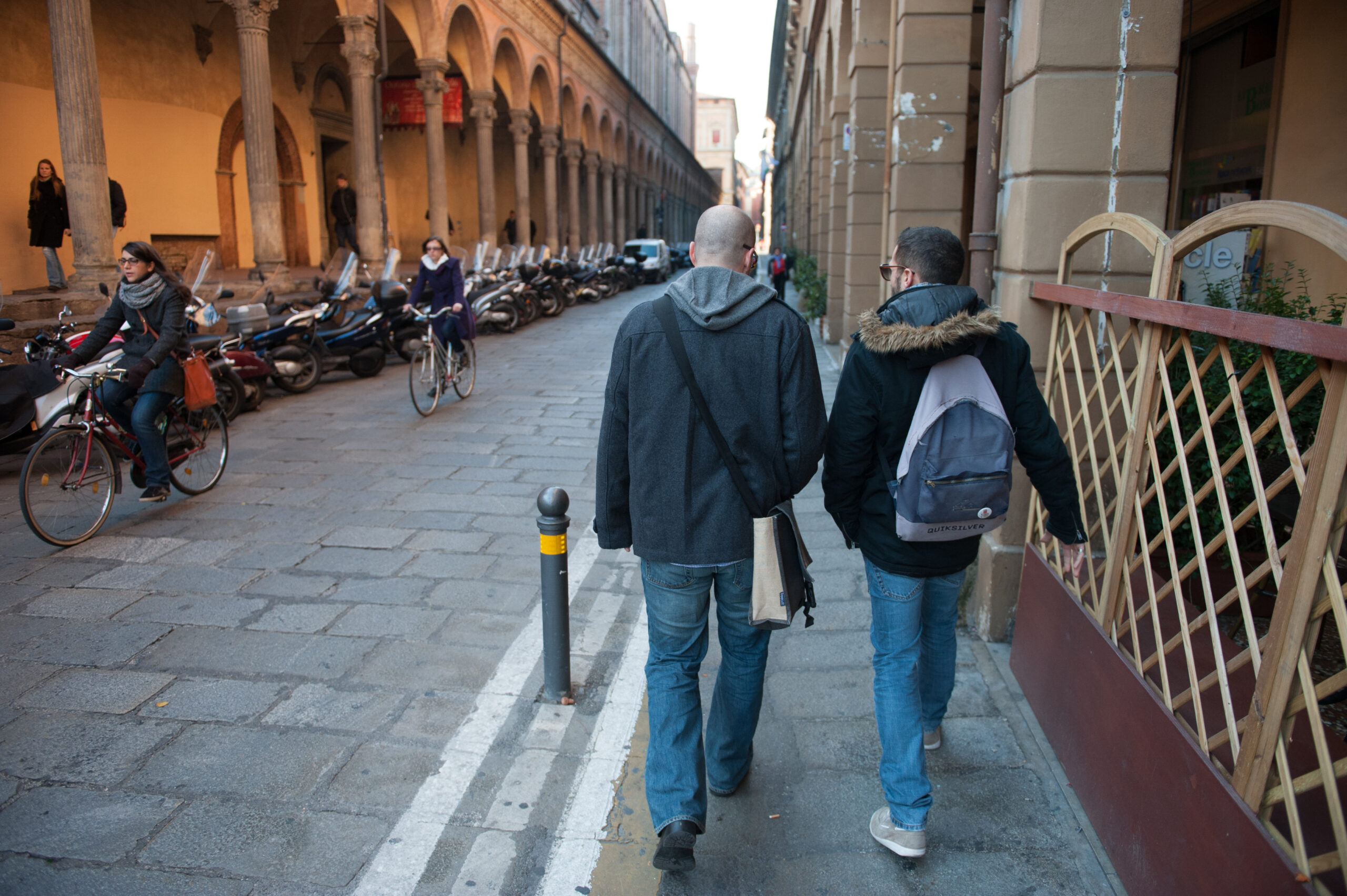 Two men walking in the city.