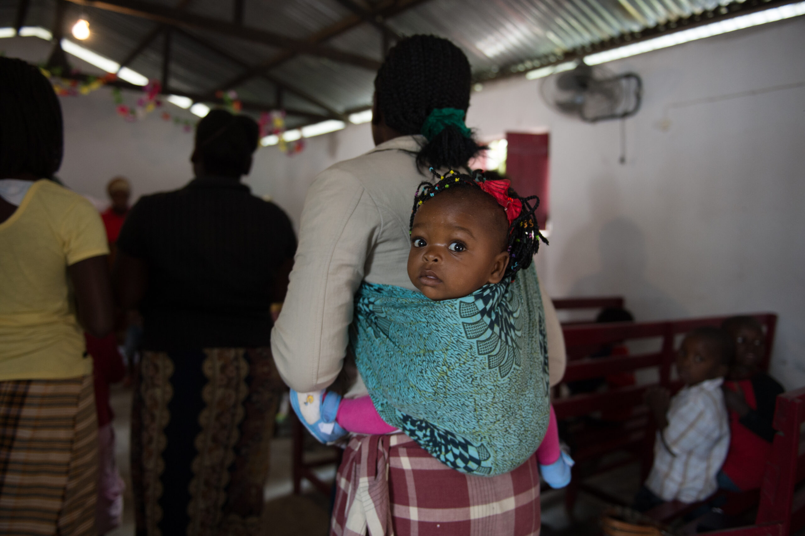 African woman with a child on her back.