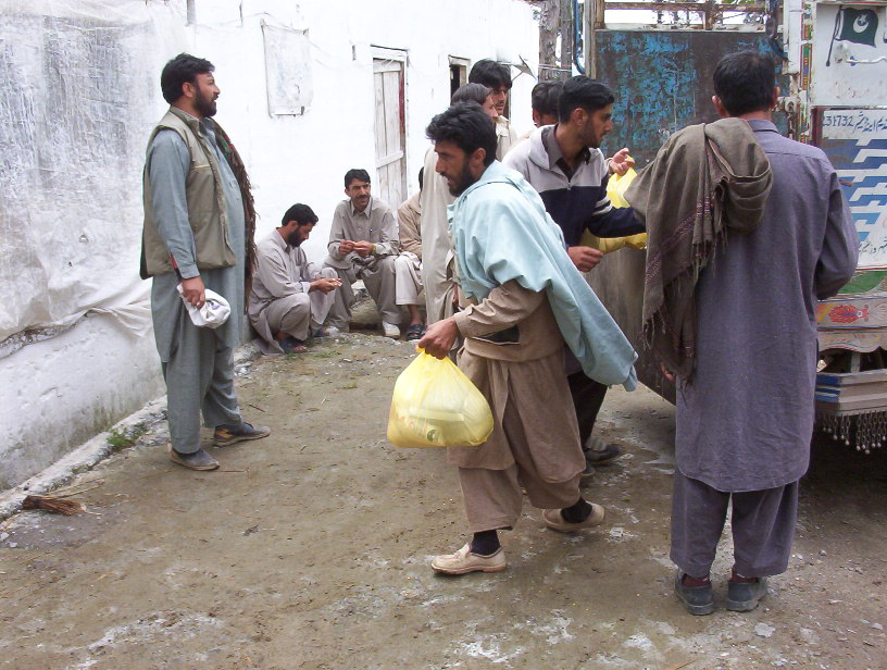 Several men with bags of supplies.