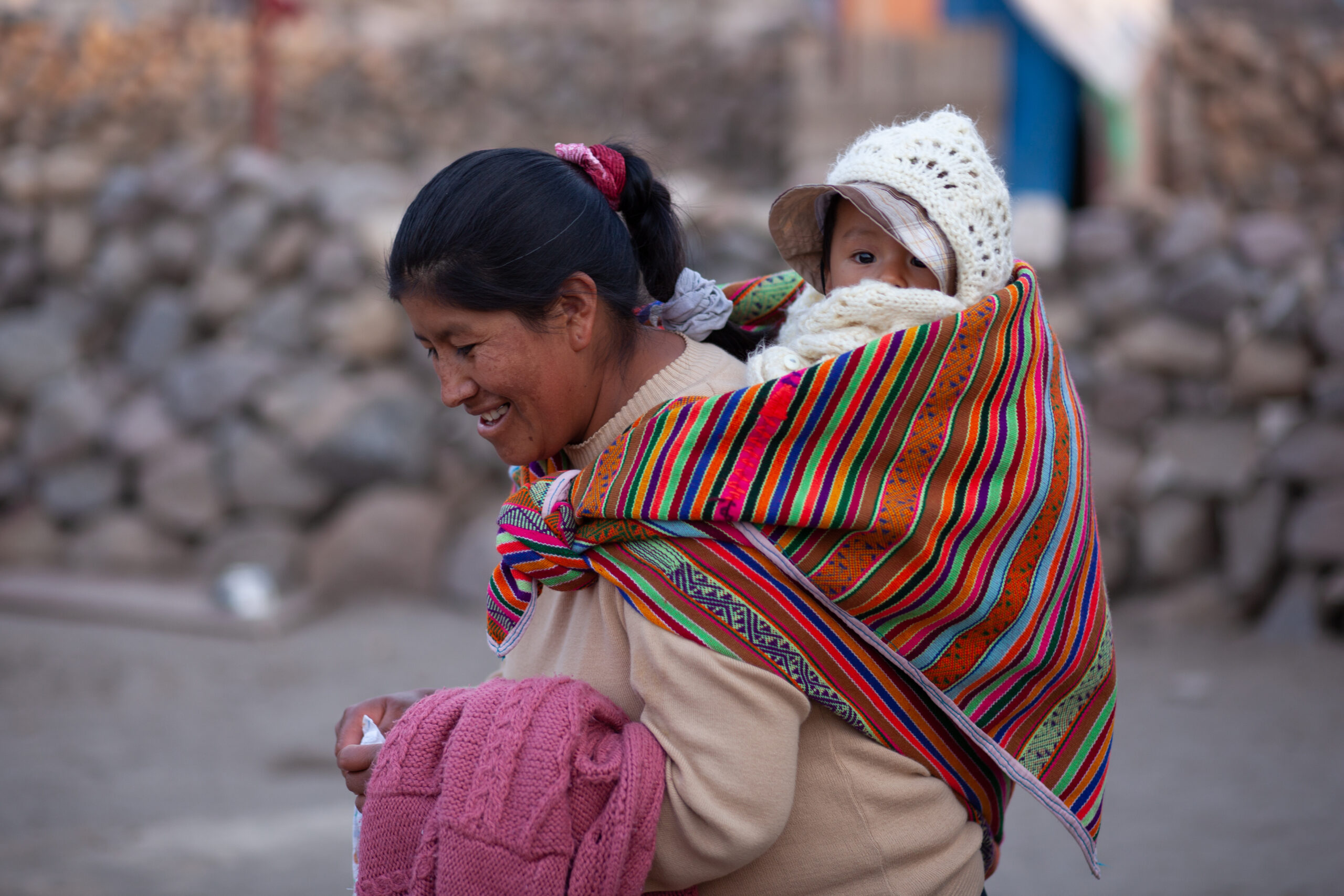 Woman with a baby on her back.