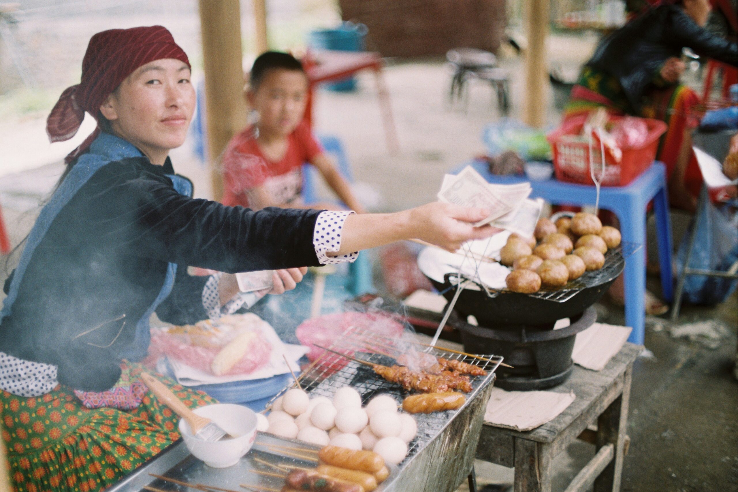 Woman street vendor handing cash back.