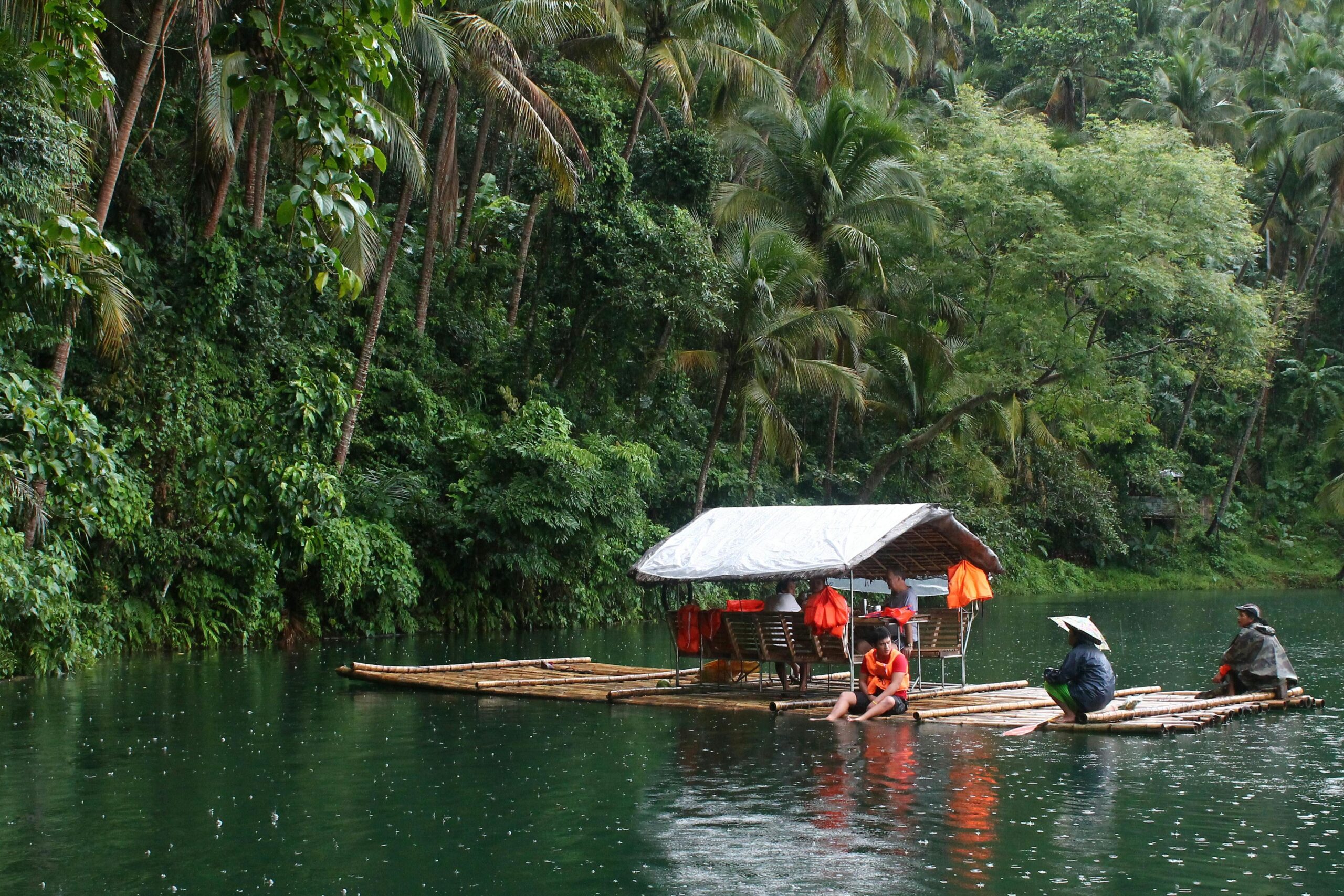 Group of people sitting on a floating raft.