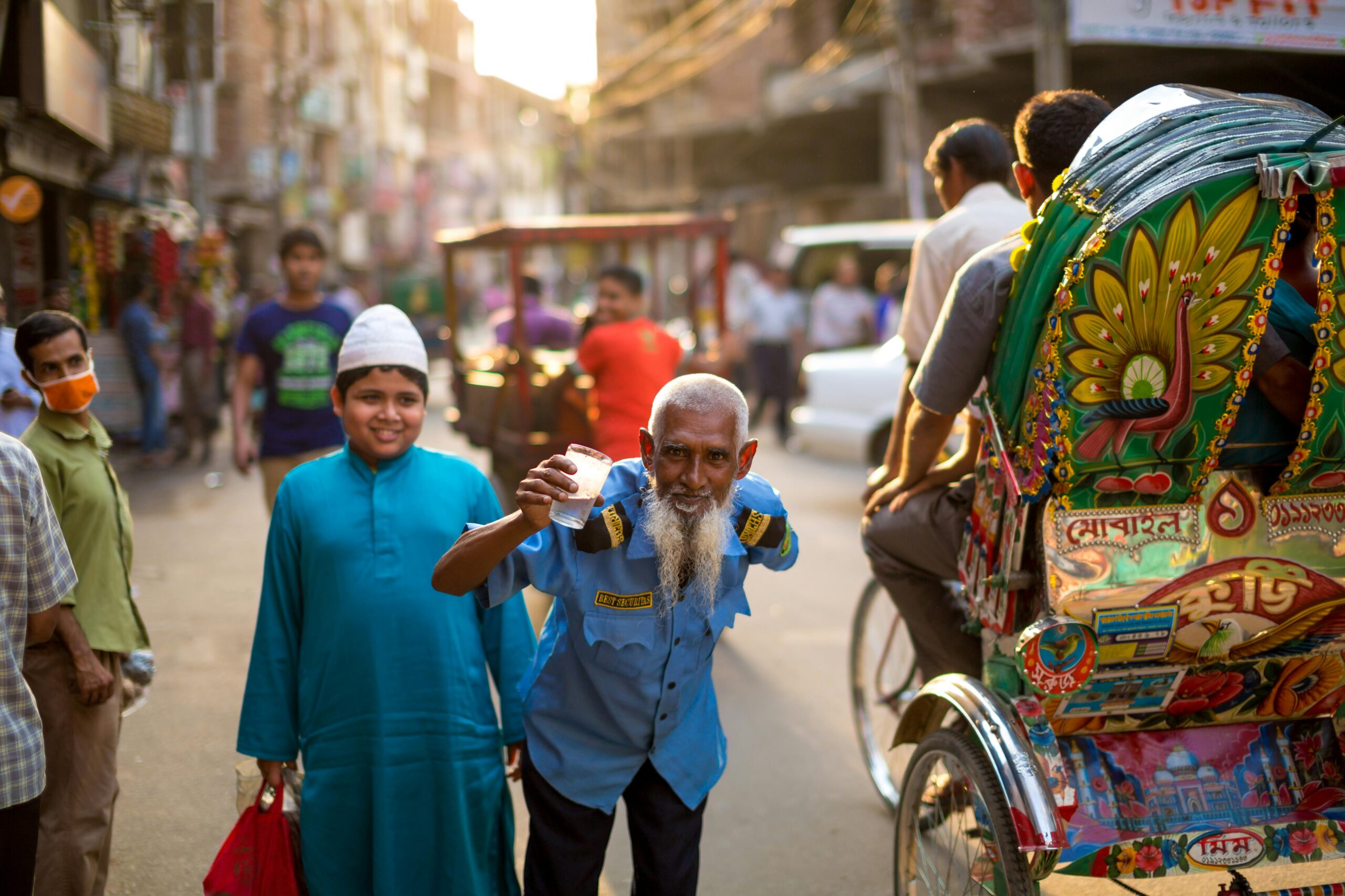 Man holding a cup in the street.