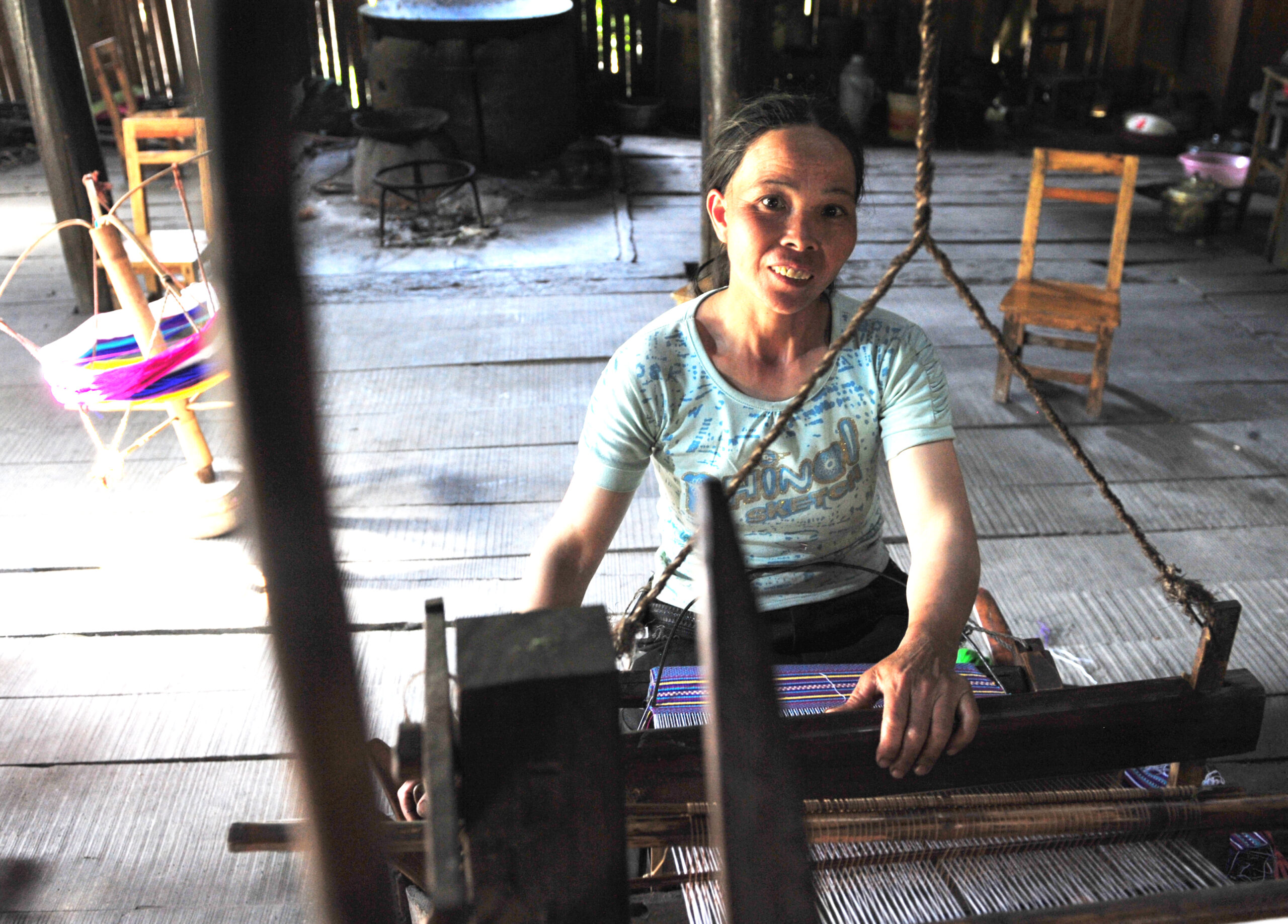 Woman working on a loom.