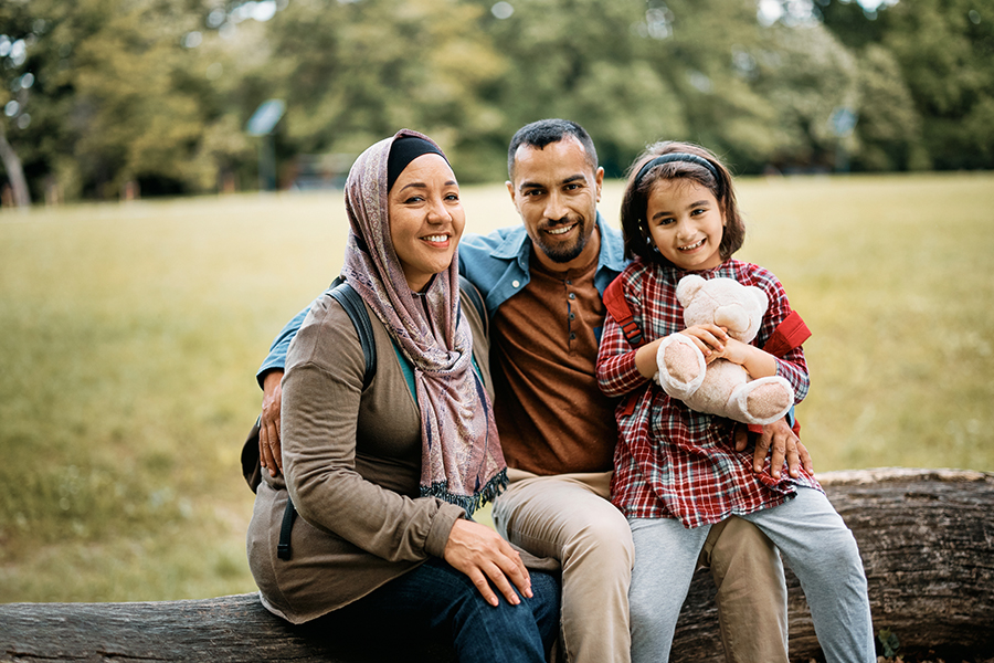 Family sitting together at the park.