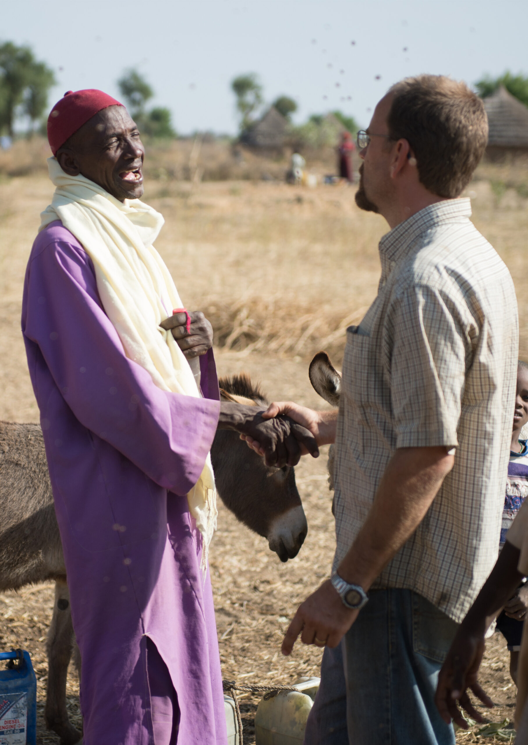 Two men shaking hands in Africa.