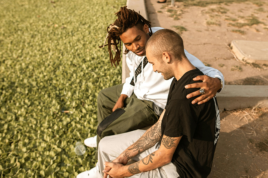 Two guys talking in the park.