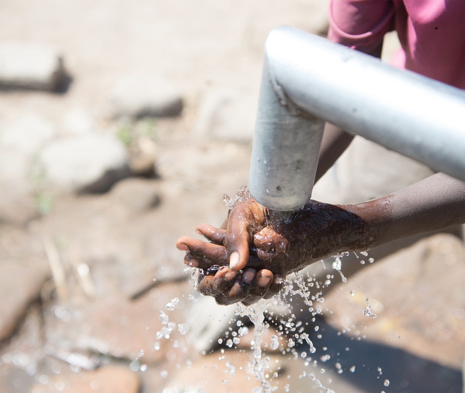 Washing hands under flowing water.