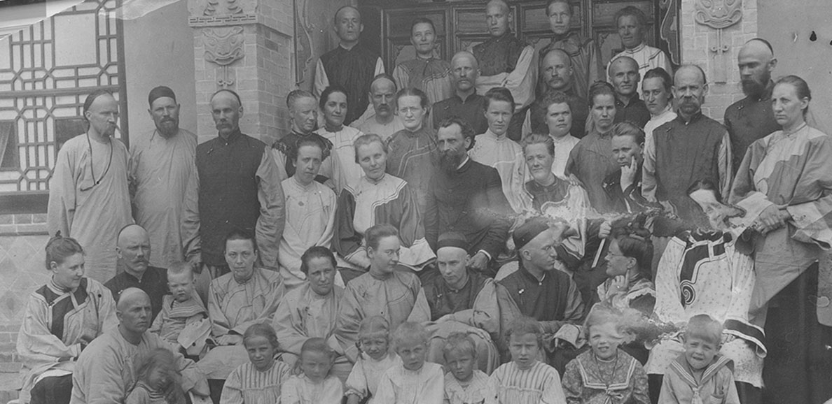 A group of missionaries pose sitting together.