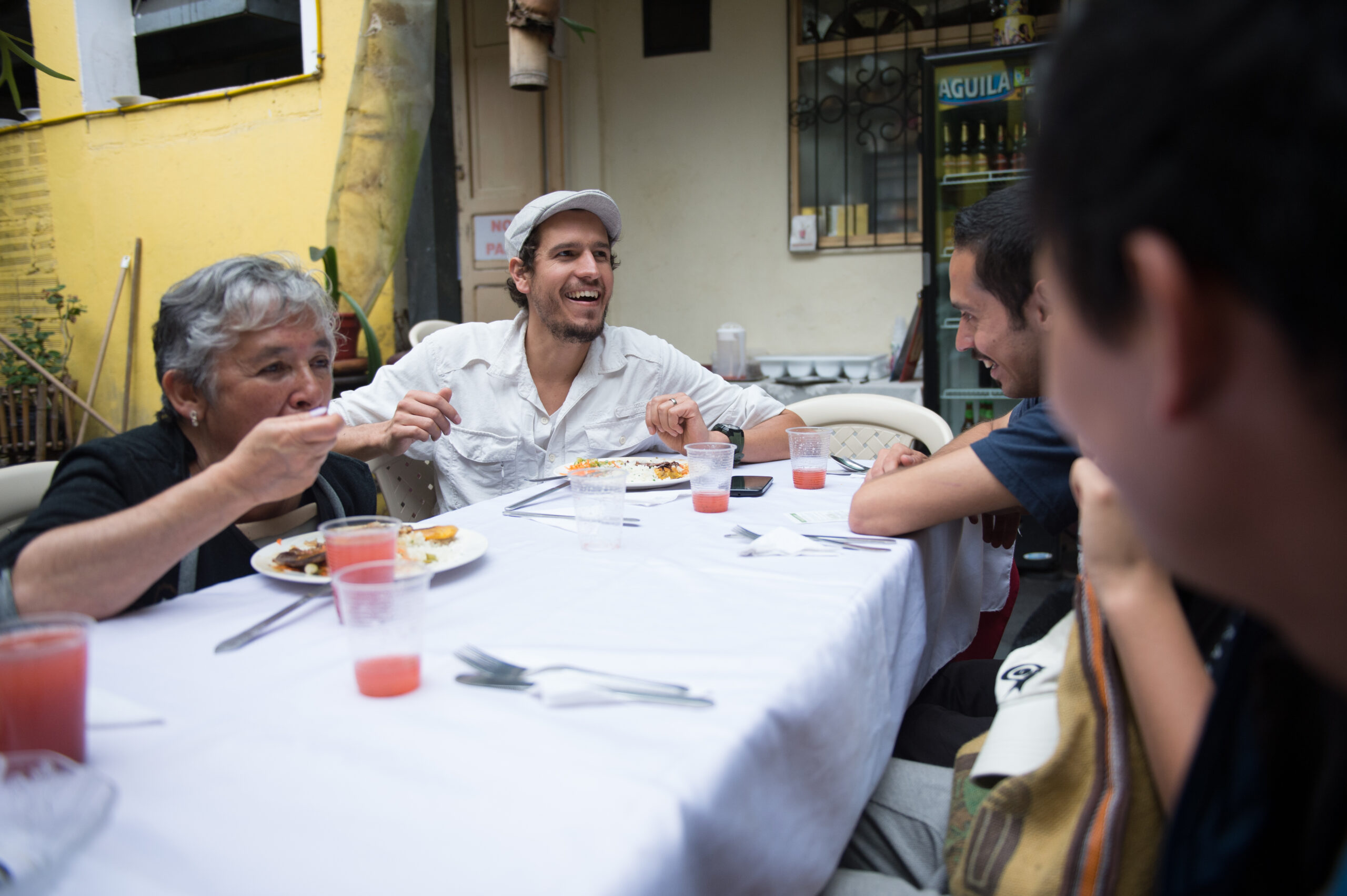 A group of people sharing a meal together and laughing.