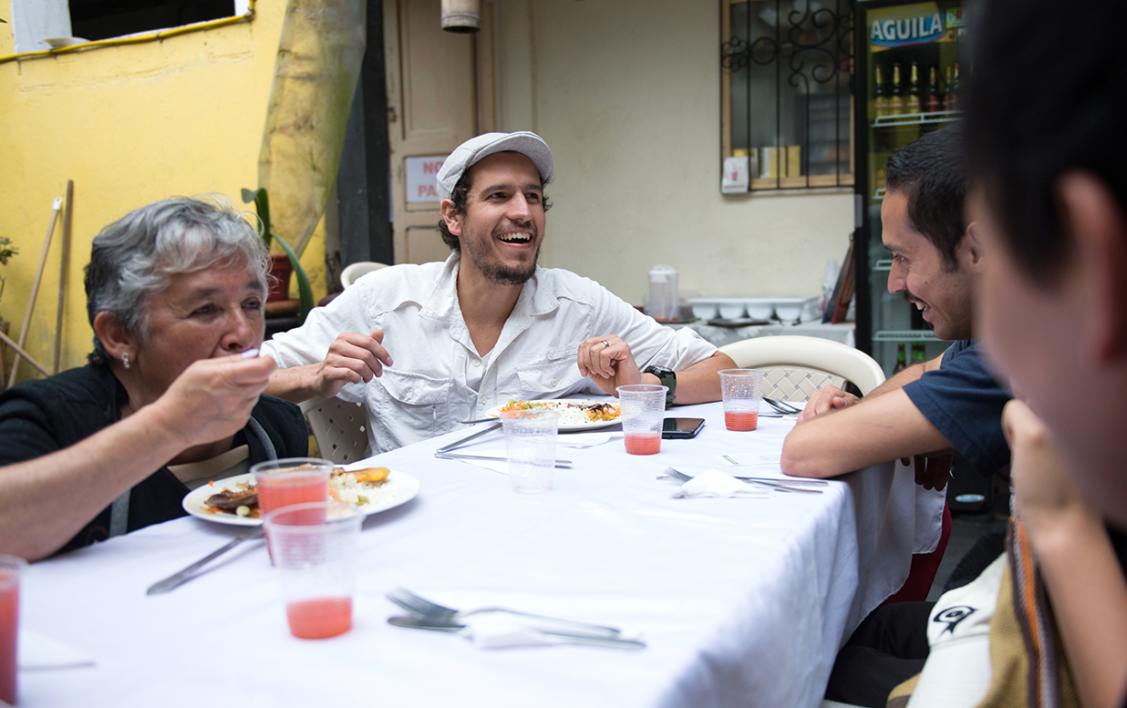 A group of people sharing a meal together and laughing.