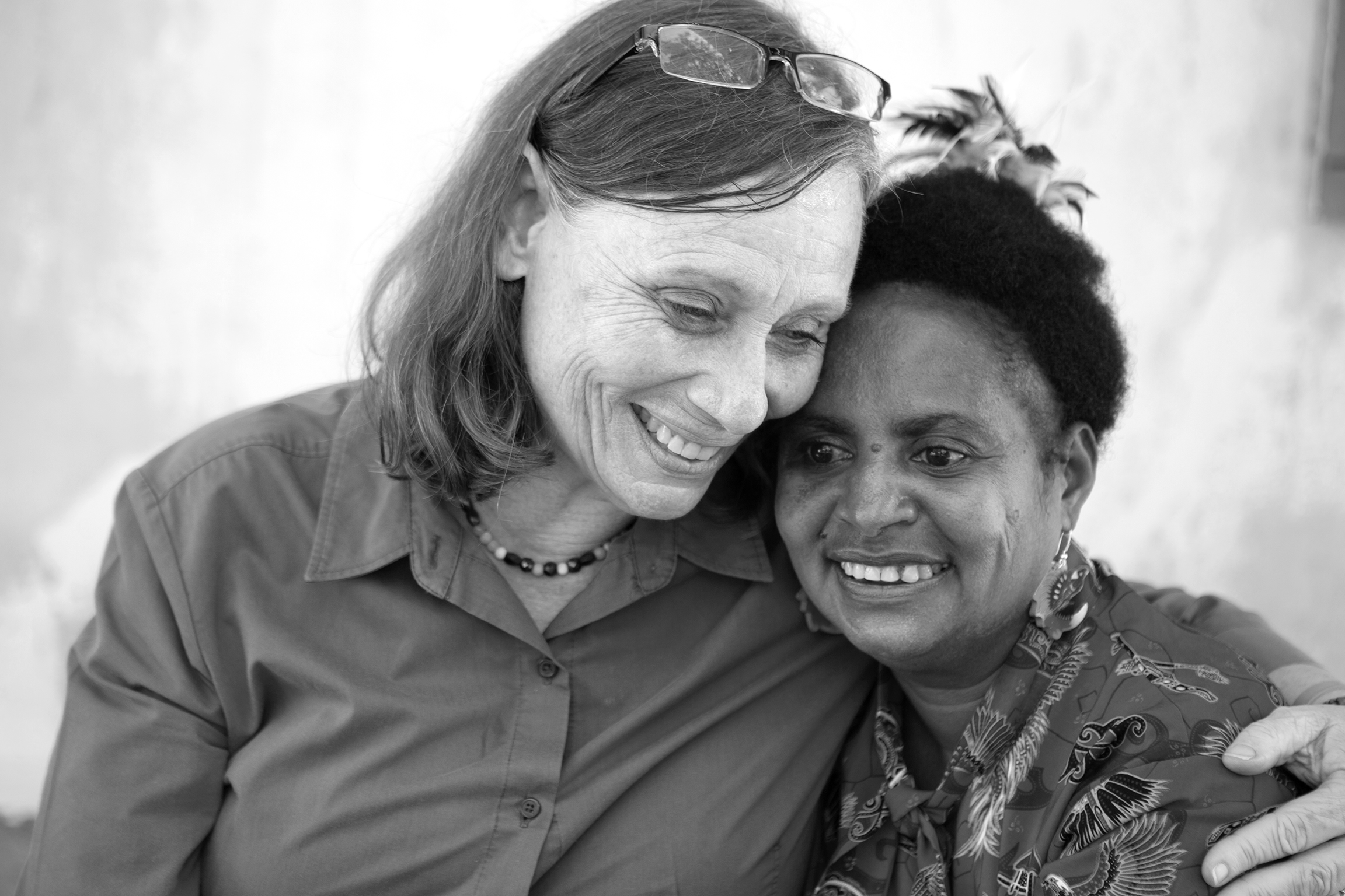 Two women hugging and smiling.