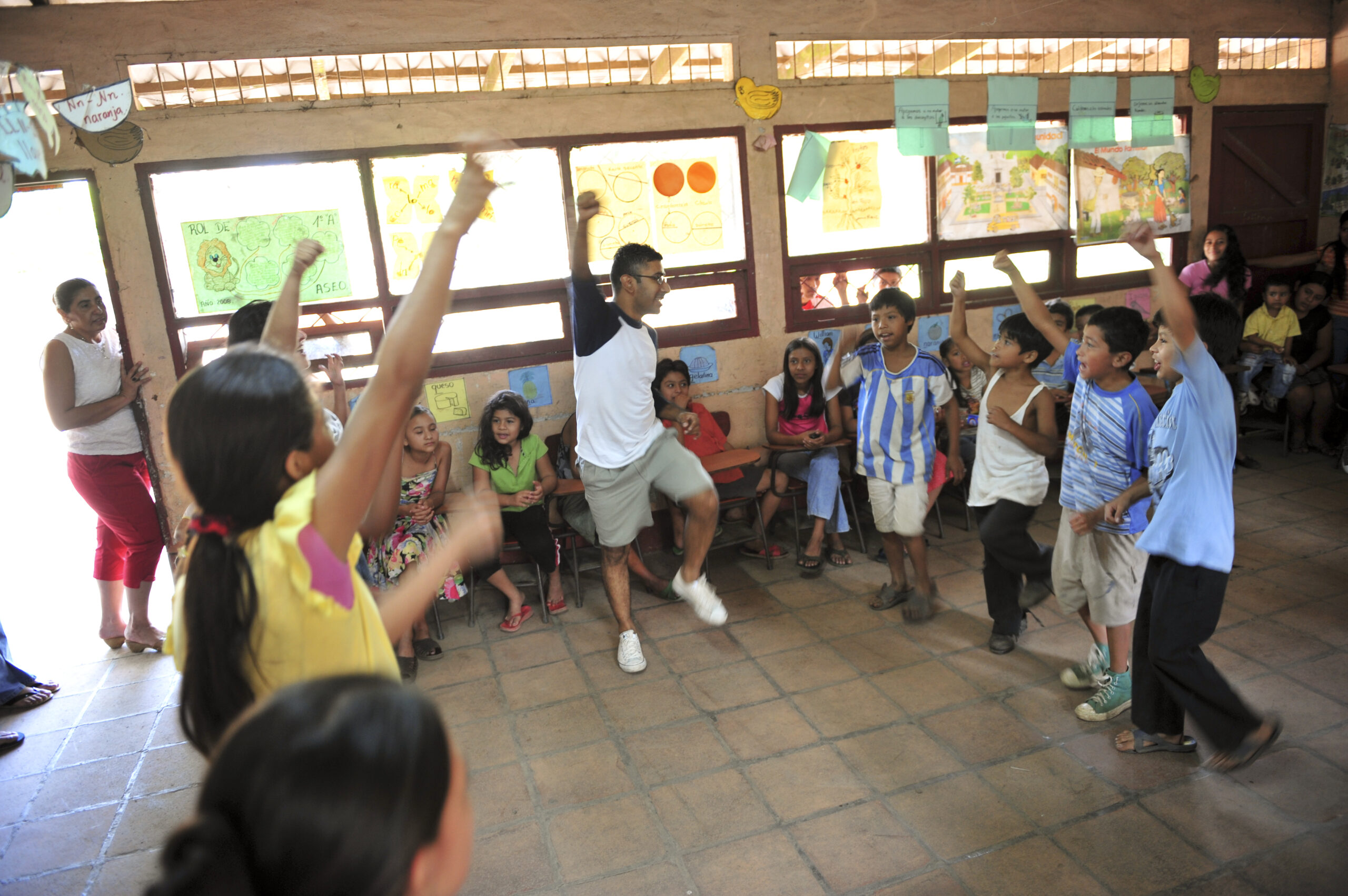 Man leading kids in a camp song.