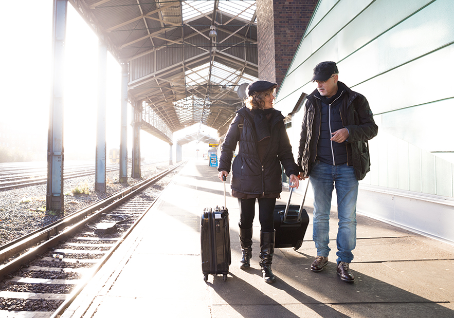 Couple walking at a train station.